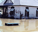 Photo of a house inundated by flooding.