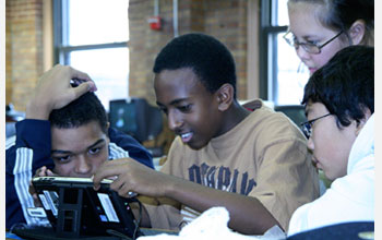 Photo of high school students playing a digital game-based learning program.