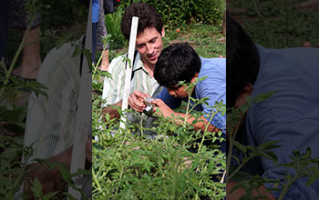 Alexey Kudryavtsev helps a Garden Mosaics Program participant photograph a community garden