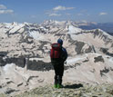 Photo of researcher viewing snow-capped mountains.