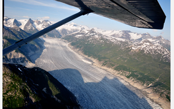 Aerial photo showing streams of melting ice covering the surface of a glacier.