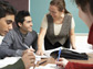 Photo of graduate students seated around a table.