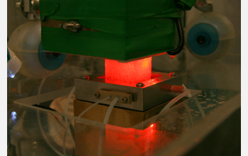 An ice core sample sits on a melter head in a cold laboratory (-20 degrees Celsius)