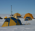 Photo of tents and the drilling rig in Greenland.