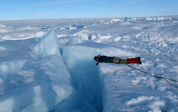 Researcher near a crevasse on the Greenland ice sheet.