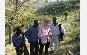 Photo of Starry Sprenkle demonstrating the use of a new GPS unit to her staffers.