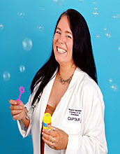 Robyn Hannigan in labcoat with bubbles