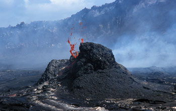 A spatter cone spits lava