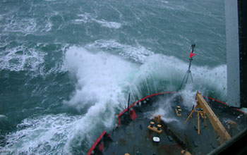 Photo of the USCGC Healy breaking through the Bering Sea waves.