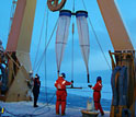 Photo of people deploying sampling nets from the stern of the Healy.