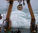 Photo of waves breaking over the fantail of the Healy.