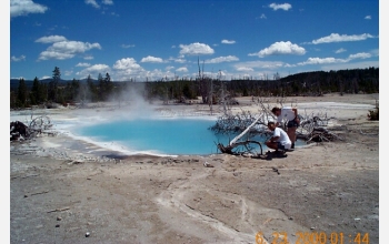 Research students take samples from a hydrothermal pool at Yellowstone National Park