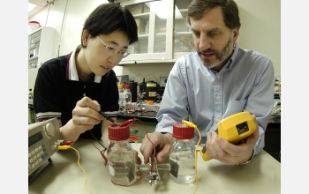 Hong Liu (left) and Bruce Logan examine an electrochemically assisted microbial reactor system