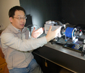 Scientist Houshuo Jiang with the new video system he developed.