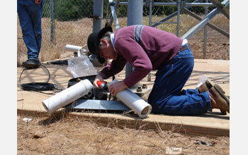 Photo of Hans-Werner Braun assembling and placing a technology on the network.