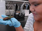 Photo of a student at Arizona States College-for-Kids holding a large South African beetle.