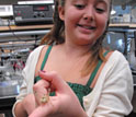 Photo of a girl holding a grasshopper at ASU's STEM Summer College-for-Kids.