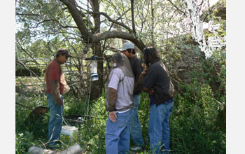Photo of William Bell with students doing research on West Nile virus.