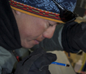 Photo of a researcher examining an ice core.