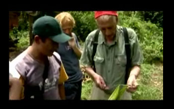 Strobel holds a plant stem as several others look on.
