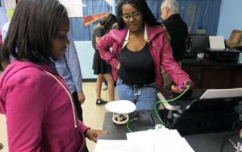 Buford Middle School students measure the output of a speaker they made with a 3-D printer.