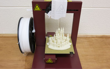 A 3-D printer and its finished product made from ABS plastic are shown.