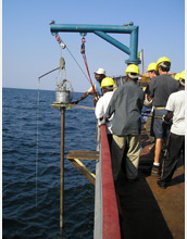 A sediment core is collected from the side of a vessel.