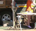 Banded mongoose roaming through a trailer in a tourist camping site.