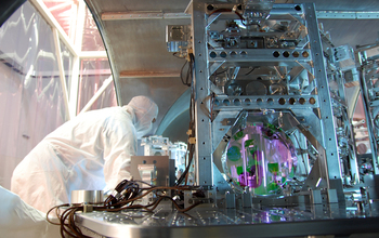LIGO power recycling mirror hangs in triple suspension on optical table inside a LIGO vacuum