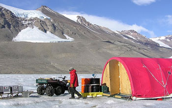Researcher at Antarctica's Dry Valleys LTER Site, with tent and equipment