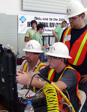 Photo of students operating a remotely operated vehicle and viewing the video feed from its camera.