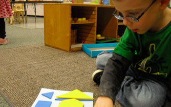 Photo of a preschooler matching shapes in the Building Blocks Shape Set.