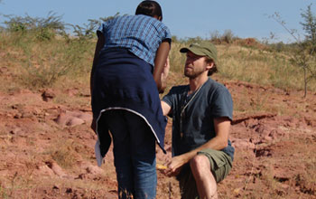 researchers looking at samples in the field