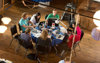 people with laptops at a table