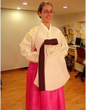Photo of Margie Serrato wearing her gift of a Hanbok, the traditional Korean dress.