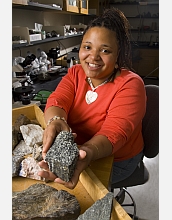 Female scientist in lab with geologic samples