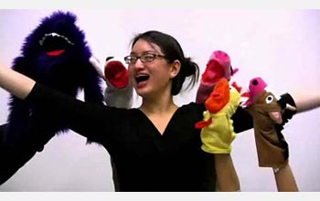 UC Berkeley junior Glry Liu cheerfully explaining nanotechnology to a band of puppets.