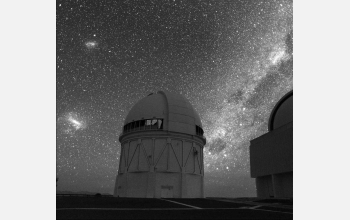 Blanco Telescope silhouetted against the Magellanic Clouds (at left) and the Milky Way