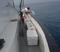 Photo of scientist Michael Beman preparing to collect seawater off the coast of southern California.