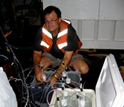 Photo of David Hutchins preparing an experiment with marine microbes.