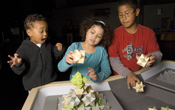 Photo of children playing with space-filling blocks.