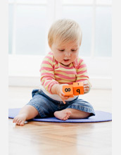 Photo of a baby playing with numbered blocks.