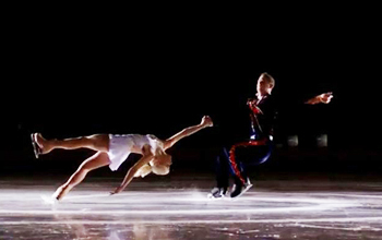 Male and female skaters performing on the ice