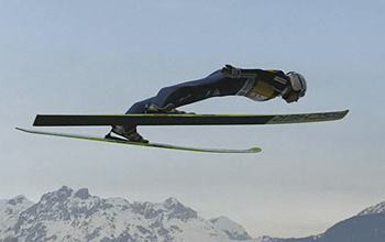 Ski jumper with mountains in background