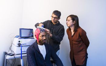Researcher Ramesh Balasubramaniam (center) works to train graduate students in brain imaging.