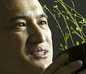 Photo of Zhen-Ming Pei and a mustard plant