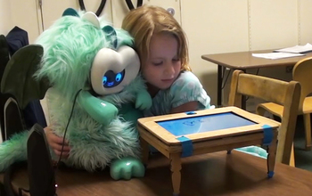A child interacts with a social robot modeled as a peer