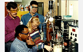 Researchers pictured with the bioreactor system they helped construct