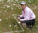 Scientist Elizabeth Borer sampling species at a wildlife reserve.