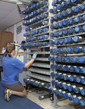 Photo of geologist Kristin Hillis labeling newly retrieved sediment cores in a shipboard lab.